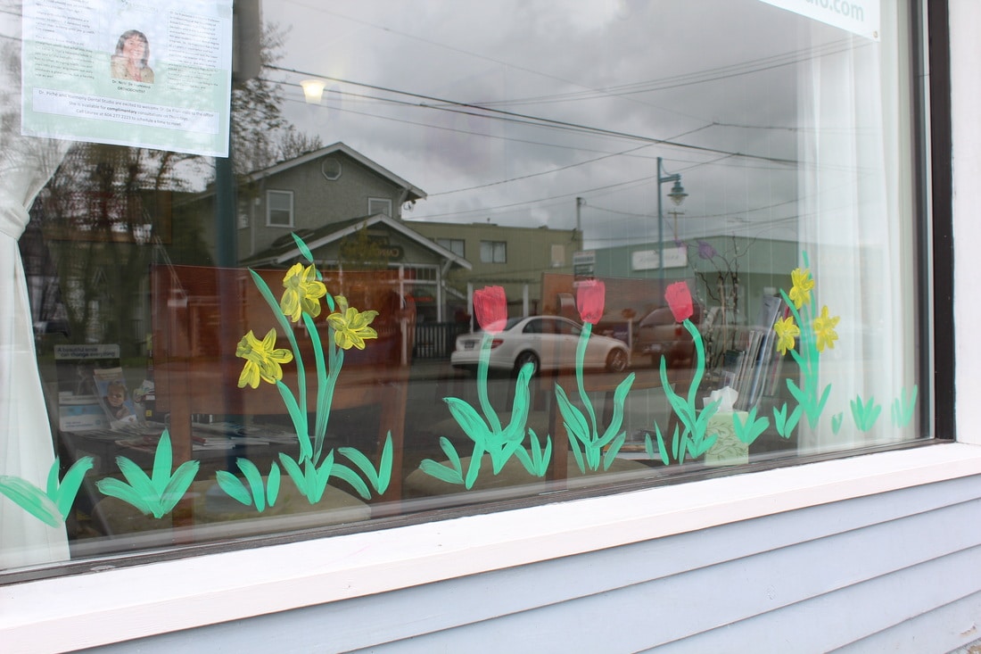 Lauree's artwork celebrates spring in our front window.